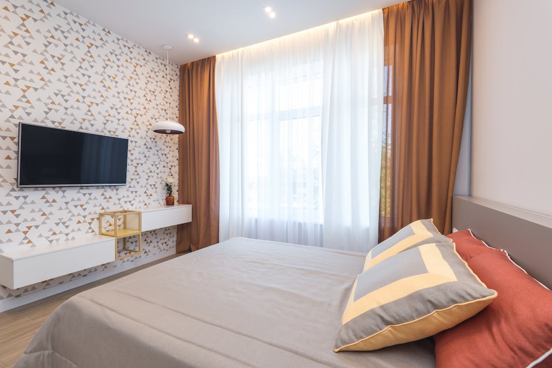 modern design bedroom with sheer curtains and complementary drapes