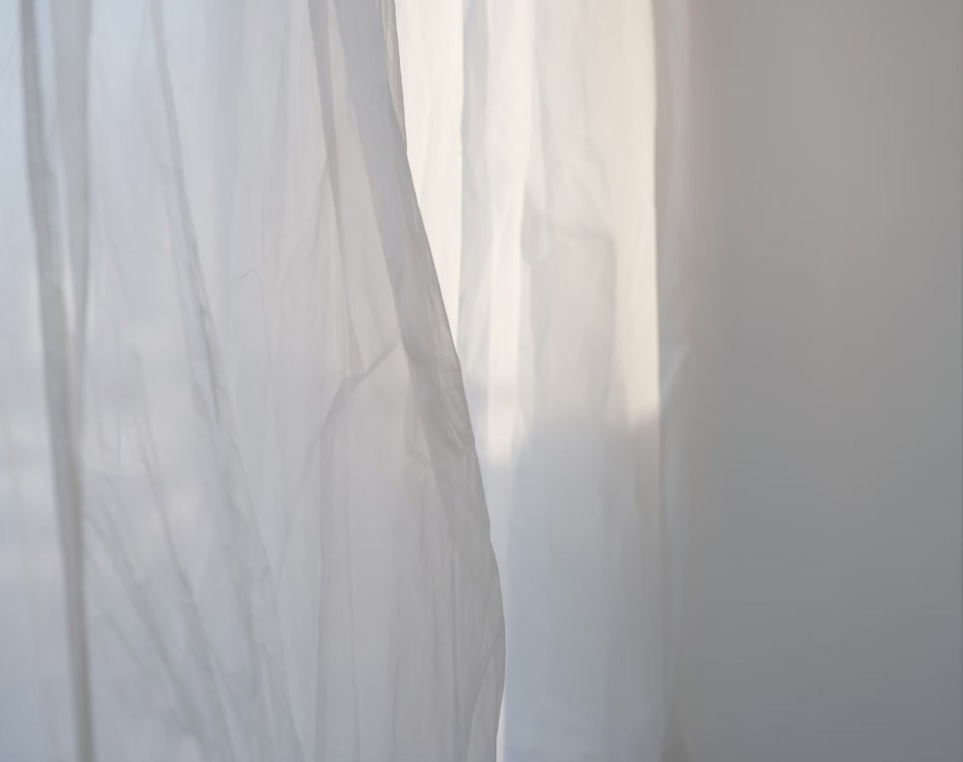 thin white curtains blowing in wind